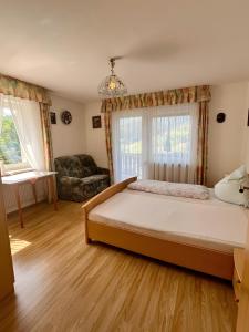 a bedroom with a large bed and a couch at Schwarzwald-Ferienwohnung Lehmann in Oppenau