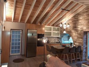 a kitchen and dining room with a table and a refrigerator at Casa das Cales in Angra do Heroísmo +30 photos