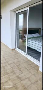 a room with a glass door with a bed on a balcony at Casa con mucha luz natural in Bisbal del Penedès