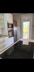 a kitchen with a counter top with a refrigerator at Casa con mucha luz natural in Bisbal del Penedès +12 photos