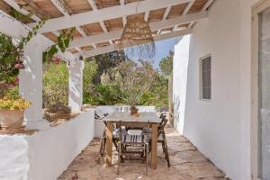 an outdoor patio with a table and chairs at Can Xicu in Illes Balears