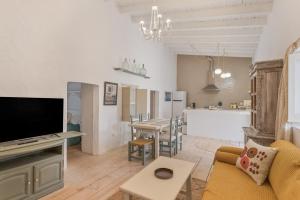 a living room with a couch and a dining room at Can Xicu in Illes Balears
