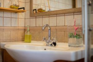 a sink in a bathroom with a glass at Arbocers in Ciutadella +20 photos
