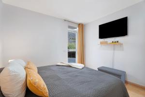 a bedroom with a bed and a flat screen tv at Vivir Bajamar in Bajamar