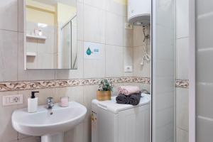 a bathroom with a sink and a toilet and a mirror at Vivir Bajamar in Bajamar +20 photos