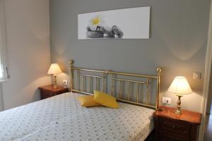 a bedroom with a bed with a yellow pillow on it at Favola Bella in Bardolino