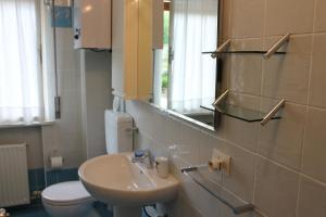 a bathroom with a sink and a toilet and a mirror at Favola Bella in Bardolino +13 photos