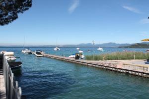 a dock with boats in a body of water at Favola Bella in Bardolino