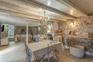 a dining room with a table and a fireplace at Toscana Di Corvo in Moya