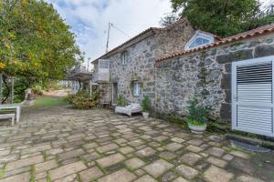 a stone patio in front of a stone house at Toscana Di Corvo in Moya