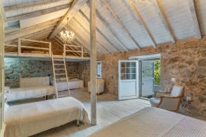 a bedroom with two bunk beds and a ladder at Toscana Di Corvo in Moya