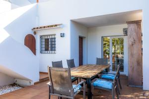 a dining room with a wooden table and chairs at Luna in Cala d´Or