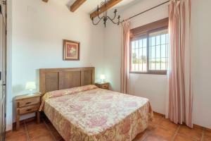 a bedroom with a bed and a window at Villa Conilsur in Conil de la Frontera +31 photos