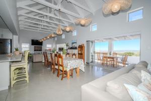 a living room with a white couch and a table and chairs at Our Father in Paternoster