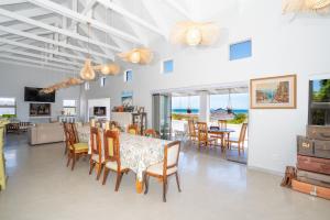 a dining room with a table and chairs and the ocean at Our Father in Paternoster