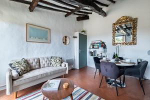 a living room with a couch and a table at Les 3 vues in Tourrettes-sur-Loup