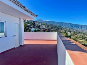 a balcony of a house with a view of the mountains at Sea view avocado Finca Ten Days in La Orotava