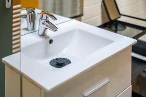 a white bathroom sink with a faucet at Les 3 vues in Tourrettes-sur-Loup +17 photos