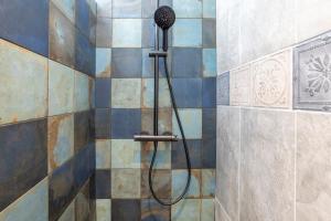 a shower with a blow dryer in a bathroom at L'Eclose Chambre Ildut in Le Guilvinec +22 photos