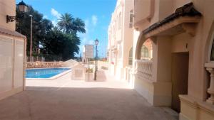 a street in a building with a swimming pool at Duquesa Beach in Torrevieja