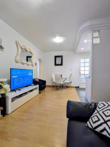 a living room with a tv and a couch at Duquesa Beach in Torrevieja