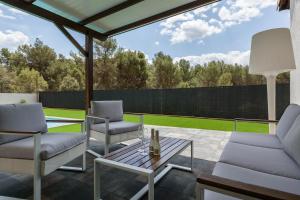 a patio with two chairs and a table at Les Roques in Castellnou de Bages