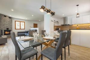 a dining room and living room with a table and chairs at Les Roques in Castellnou de Bages