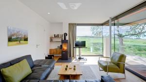 a living room with a couch and a table at Ferienhaus Wreechen 25, Haus 1 in Putbus