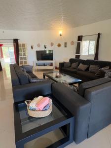 a living room with two couches and a tv at Villa Maria in Cap Skirring