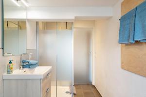 a bathroom with a sink and a mirror at Pur Wohnen - Wohnung Fernsicht in Bad Griesbach +22 photos