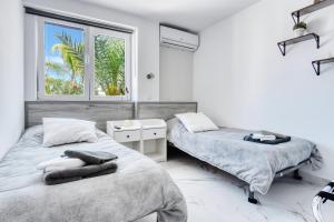 two beds in a white room with a window at Park Carpe Diem in Busot +28 photos