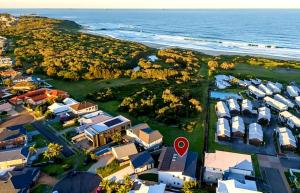 an aerial view of a resort near the ocean at Surfside Getaway Caves Beach Absolute Beachfront in Caves Beach
