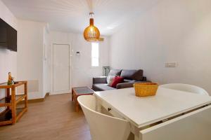 a living room with a table and a couch at Falco 3 in Corralejo
