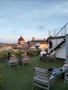 a group of people sitting in chairs on a patio at Hotel Cantoria in Florence