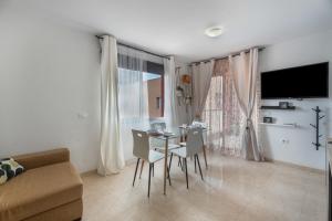 a living room with a table and chairs and a couch at Apartamento Erma Candelaria in Candelaria