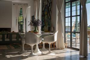 a dining room with a table and chairs in a room at Villa Celeste-Essaouira, piscine chauffée, vue sur la campagne in Essaouira +32 photos