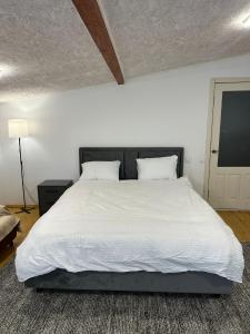 a bedroom with a large bed with white sheets and pillows at HomeRent Bucuresti Studio in Chişinău