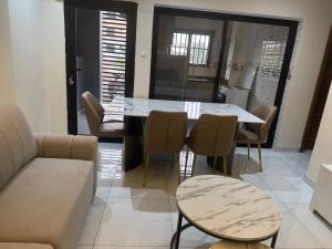 a dining room with a table and chairs at IMMEUBLE COSMOS Kintambo in Kinshasa