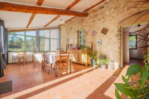 a kitchen and dining room with a table and chairs at Perles De Aime in Laurac-en-Vivarais +56 photos