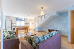 a living room with two couches and a piano at Las Gargantas de Gredos in Burgohondo