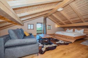 a living room with a couch and a bed at Englburger Hof in Tittling