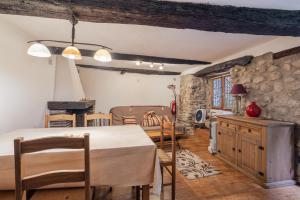 a kitchen and dining room with a table and chairs at Au Petit Paris, Centre de Céret in Céret