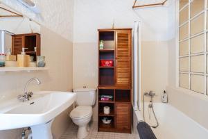a bathroom with a sink and a toilet and a tub at Au Petit Paris, Centre de Céret in Céret +12 photos