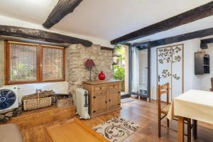 a living room with a stone wall at Au Petit Paris, Centre de Céret in Céret