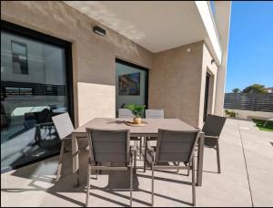 a dining room table and chairs on a patio at R-53 Corner Villa with private pool in Los Montesinos