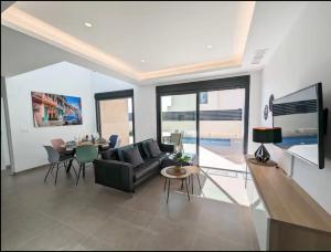 a living room with a couch and a table at R-53 Corner Villa with private pool in Los Montesinos