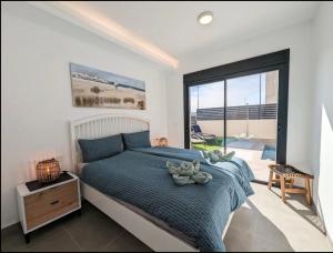 a bedroom with a large bed and a large window at R-53 Corner Villa with private pool in Los Montesinos +21 photos