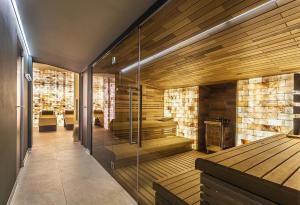 a sauna with wooden walls and a glass door at Apartment Katrin Harrachov Resident - Sauna world free in Harrachov