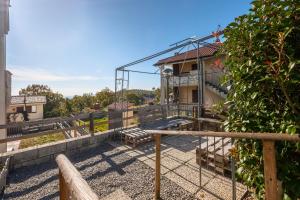 a view of a building with a fence at Terrazza Catabbio in Catabbio