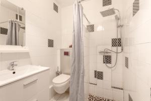 a white bathroom with a toilet and a sink at Chalets De L'arriutort 1 - Laruns in Laruns +12 photos
